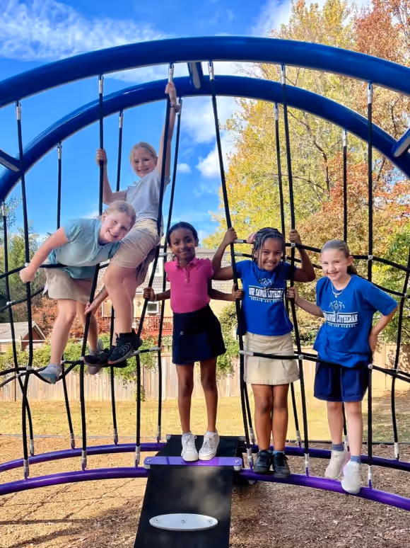 Students playing together on playground equipment
